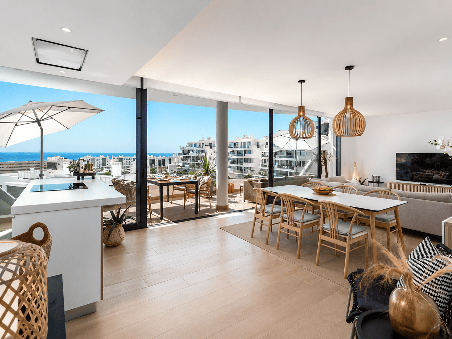 Higuerón West Residence — bright open-plan living and dining space with Mediterranean sea views